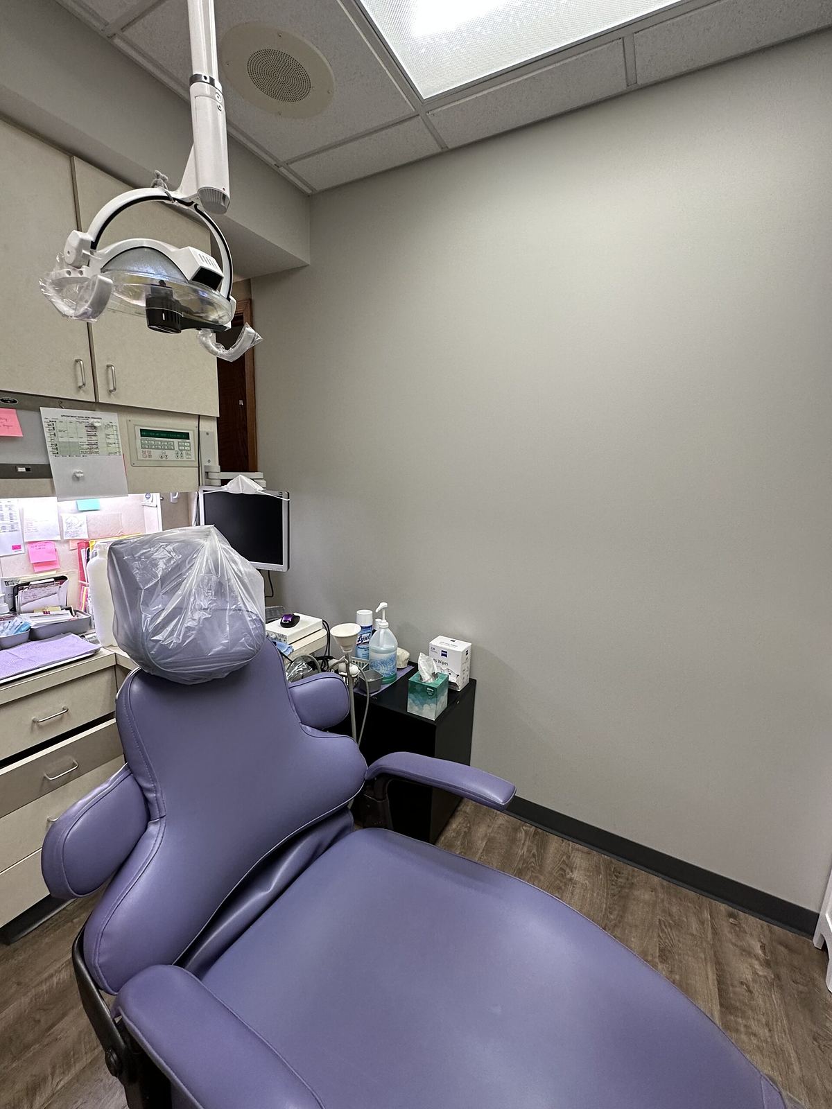 A second treatment room at Worth Palos Dentistry, showing the chair, overhead light and instrument cabinetry